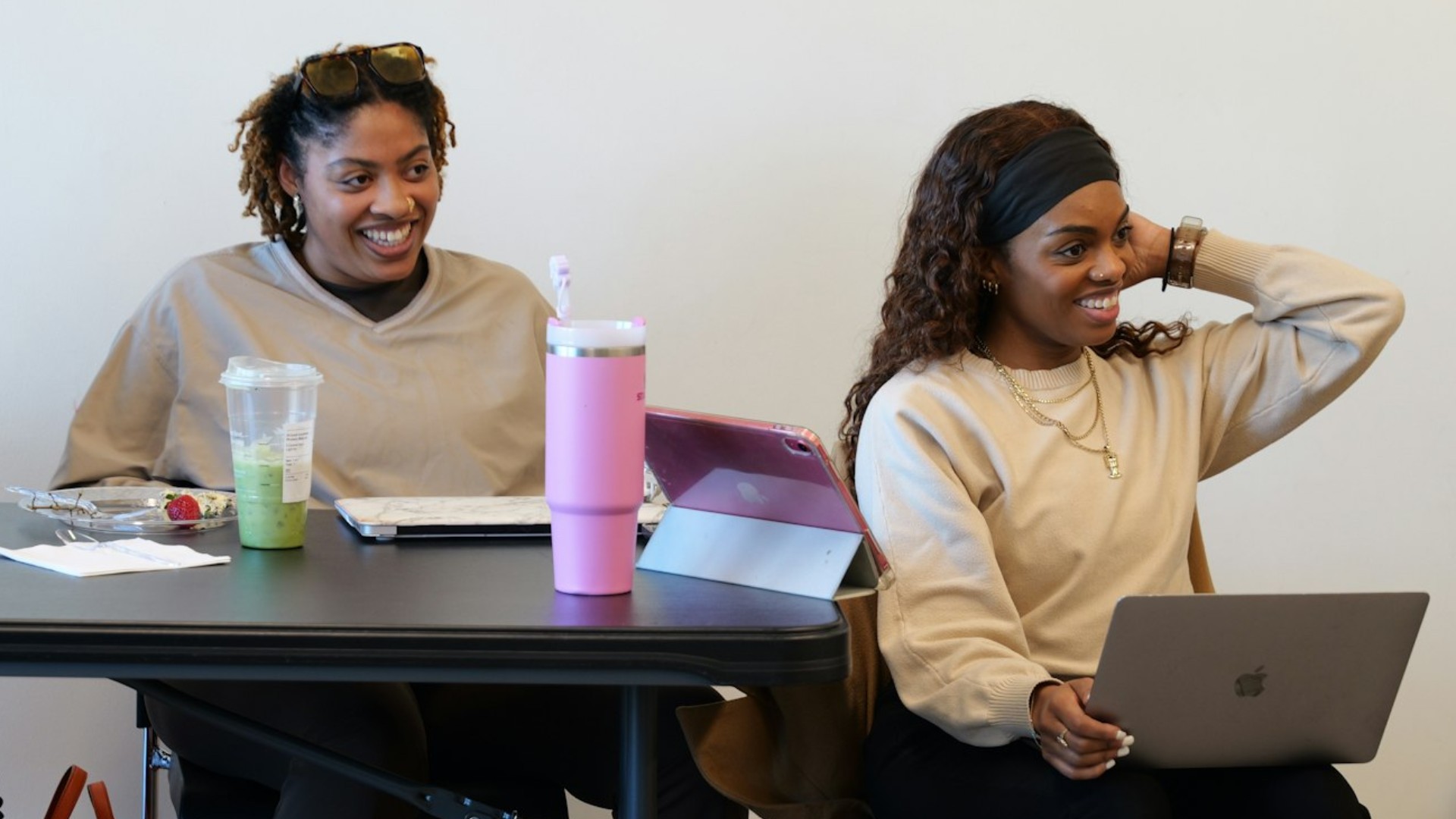 Two North Carolina Black Alliance workers share a laugh during a meeting.